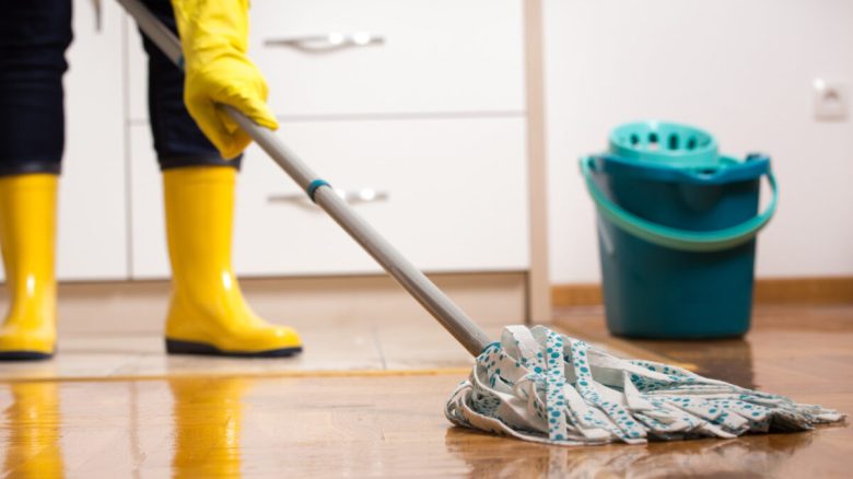 Housekeeper mopping tiled floor