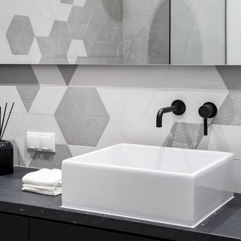 Countertop washbasin with black faucet