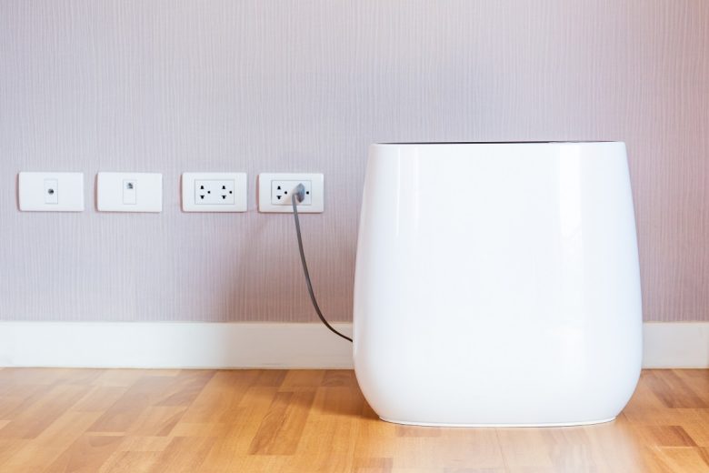 Modern portable air purifier in the room close up.