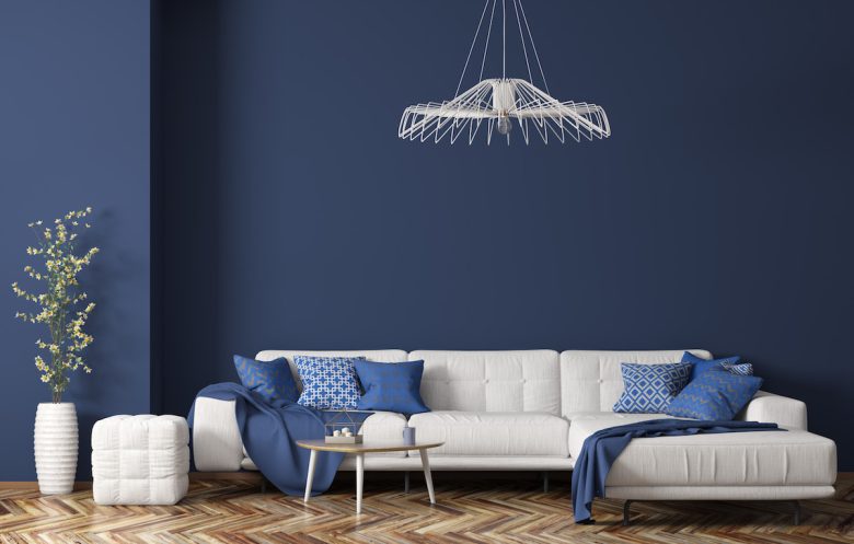 Interior of modern living room with white fabric sofa over blue wall 3d rendering