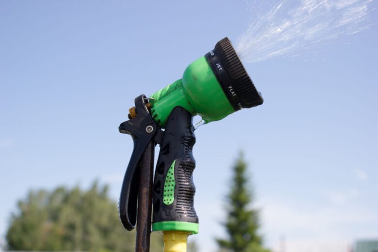 41674679 - watering lawn grass with a shower sprayer head
