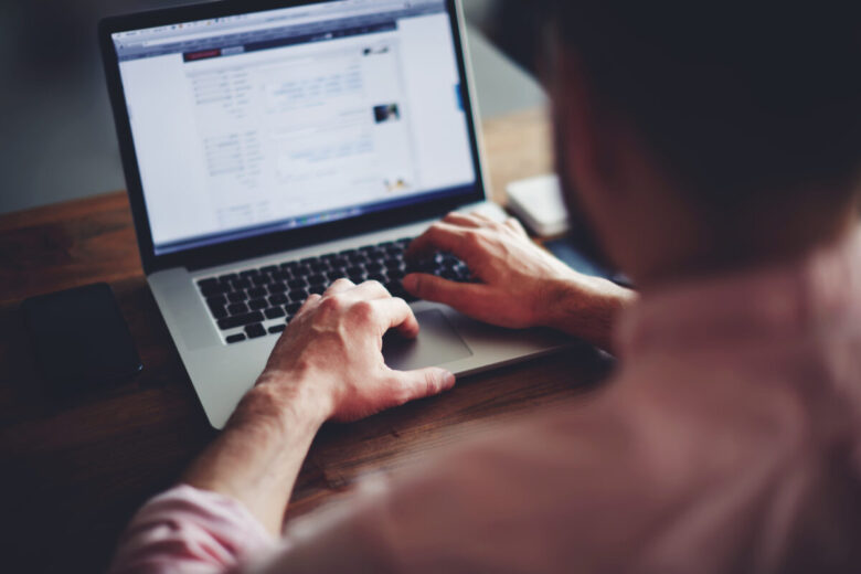 Cropped,Image,Of,A,Young,Man,Working,On,His,Laptop