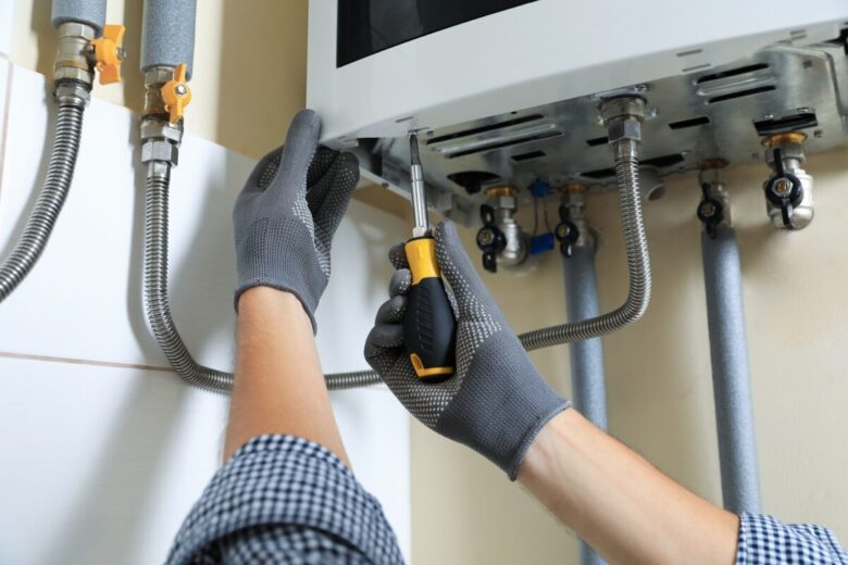 Man,Repairing,Gas,Boiler,With,Screwdriver,Indoors,,Closeup