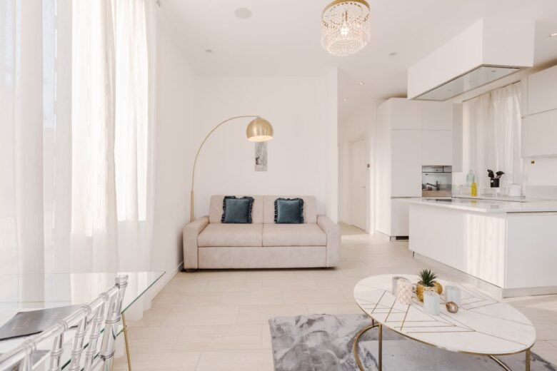 Bright and airy contemporary living room with minimalist design and white furnishings.