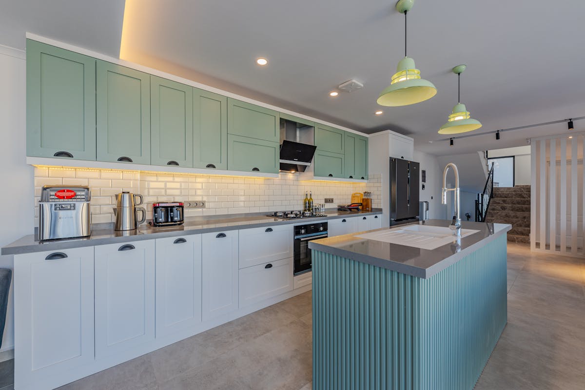Stylish kitchen featuring contemporary design, an island, and modern appliances. Stylish kitchen featuring contemporary design, an island, and modern appliances.