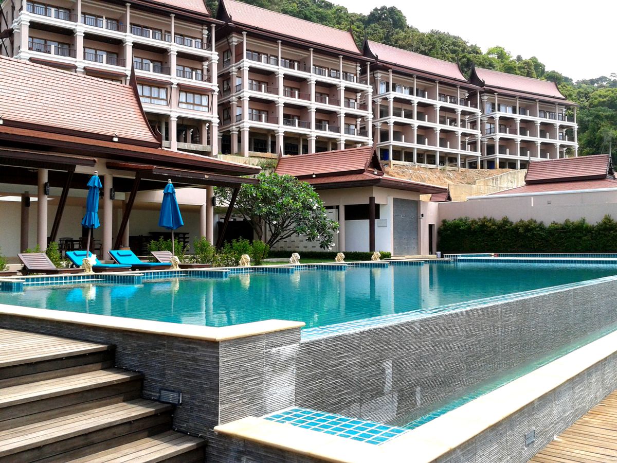 Relaxing tropical resort with a pristine pool and modern architecture, perfect for a summer getaway. Relaxing tropical resort with a pristine pool and modern architecture, perfect for a summer getaway.