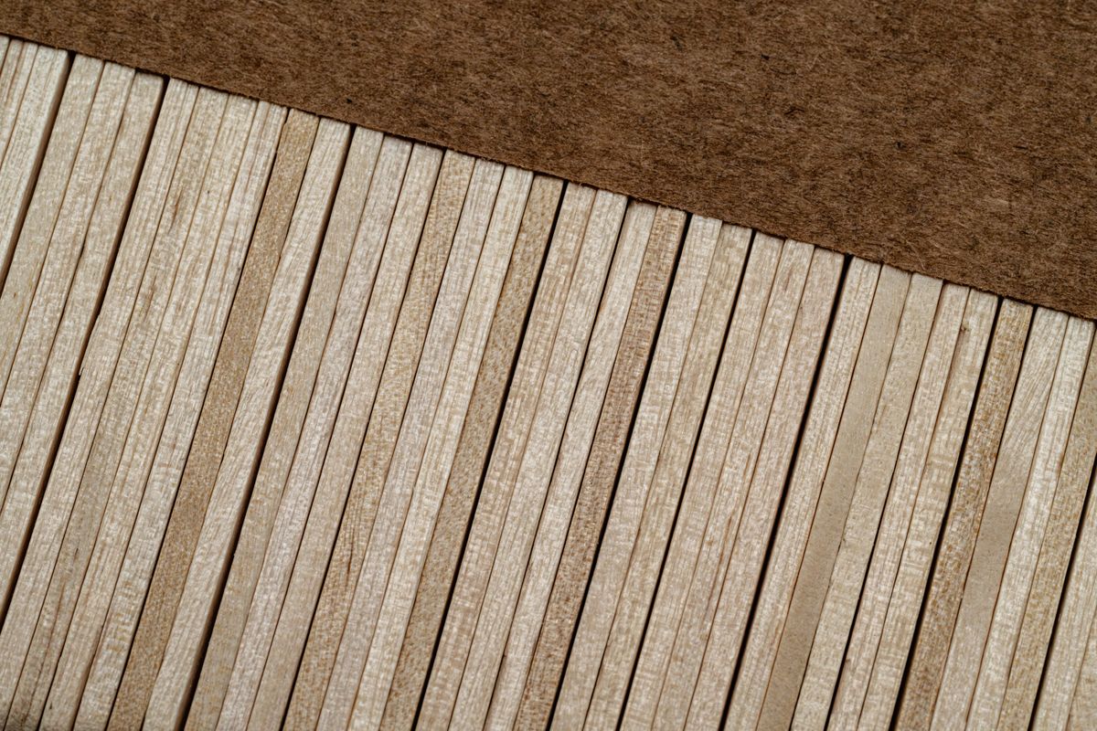 An artistic close-up shot of parallel wooden planks creating a textured pattern. An artistic close-up shot of parallel wooden planks creating a textured pattern.
