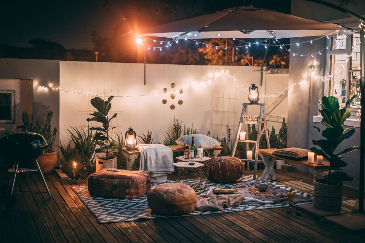 Inviting outdoor patio setup at night featuring cozy seating, string lights, and decor for perfect relaxation. Inviting outdoor patio setup at night featuring cozy seating, string lights, and decor for perfect relaxation.