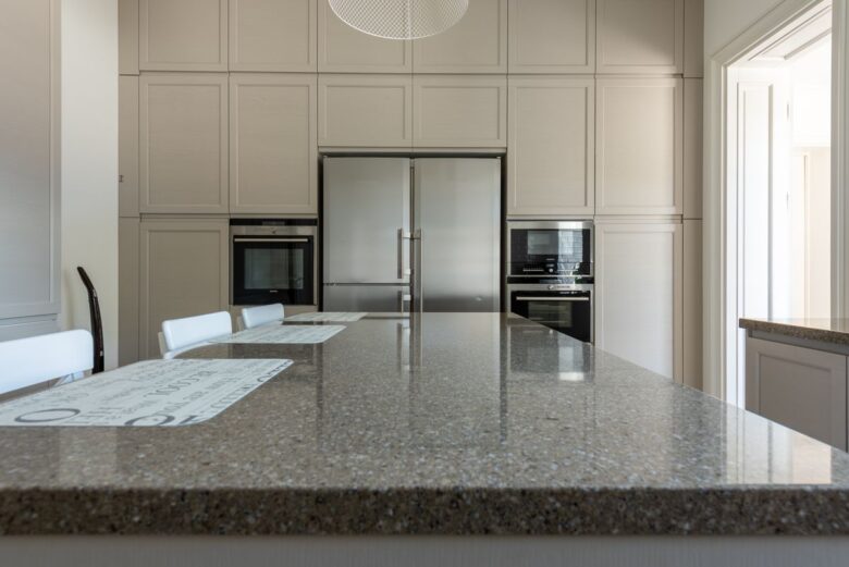Sleek modern kitchen featuring granite countertops and stainless steel appliances.