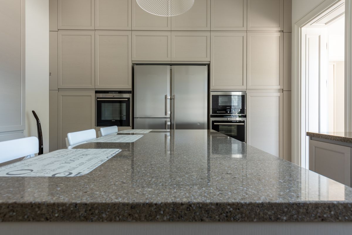 Sleek modern kitchen featuring granite countertops and stainless steel appliances. Sleek modern kitchen featuring granite countertops and stainless steel appliances.