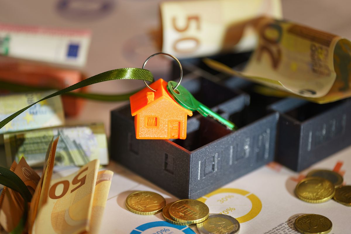 Image depicting real estate investment with keychain, euros, and financial charts. Image depicting real estate investment with keychain, euros, and financial charts.