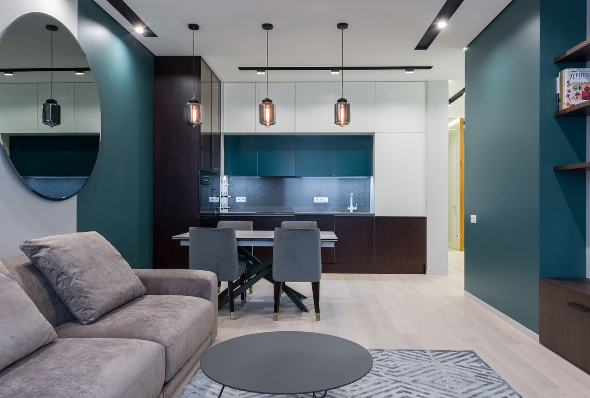 Interior of contemporary apartment with comfortable furniture in living room and kitchen in daylight Interior of contemporary apartment with comfortable furniture in living room and kitchen in daylight