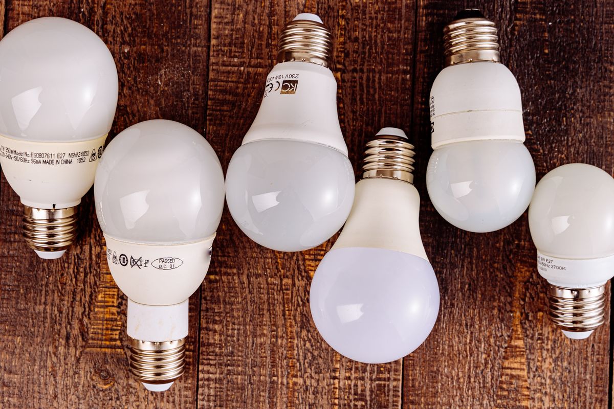 LED light bulbs arranged on a wooden surface, showcasing their modern design. LED light bulbs arranged on a wooden surface, showcasing their modern design.