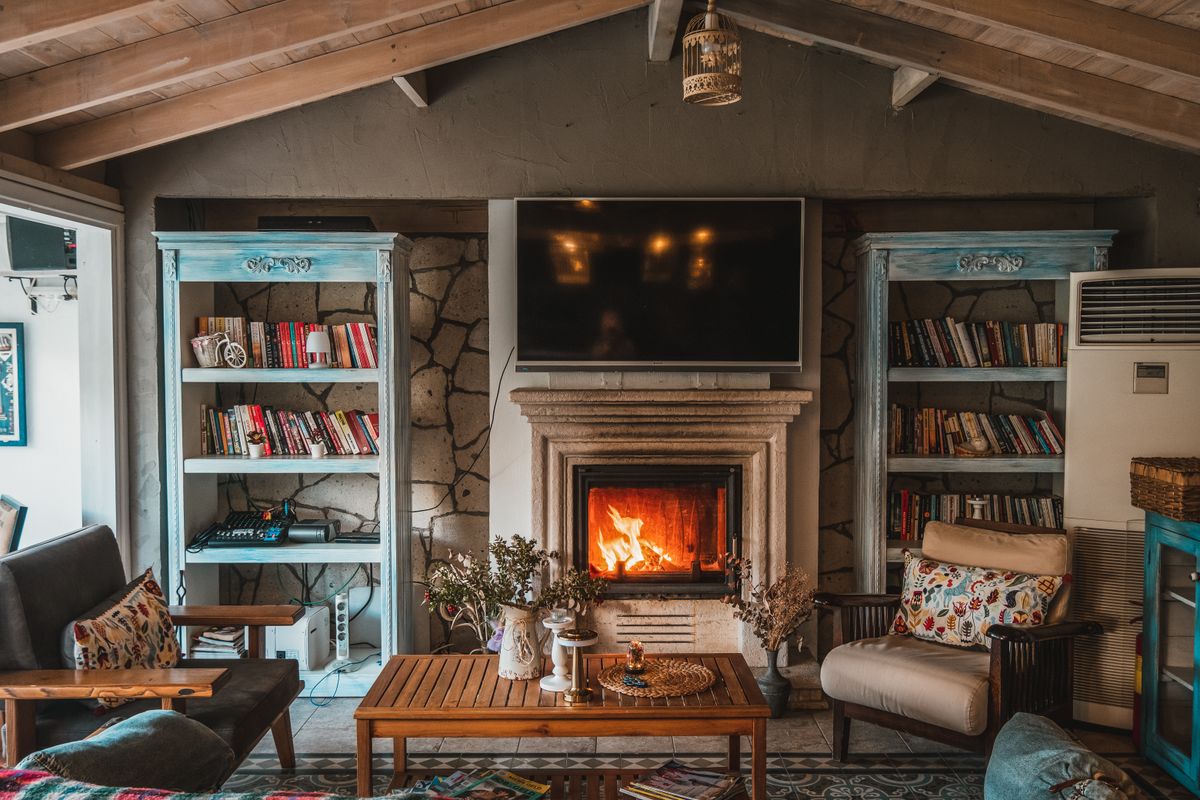 Warm and inviting living room featuring a cozy fireplace and decorative bookshelves. Warm and inviting living room featuring a cozy fireplace and decorative bookshelves.