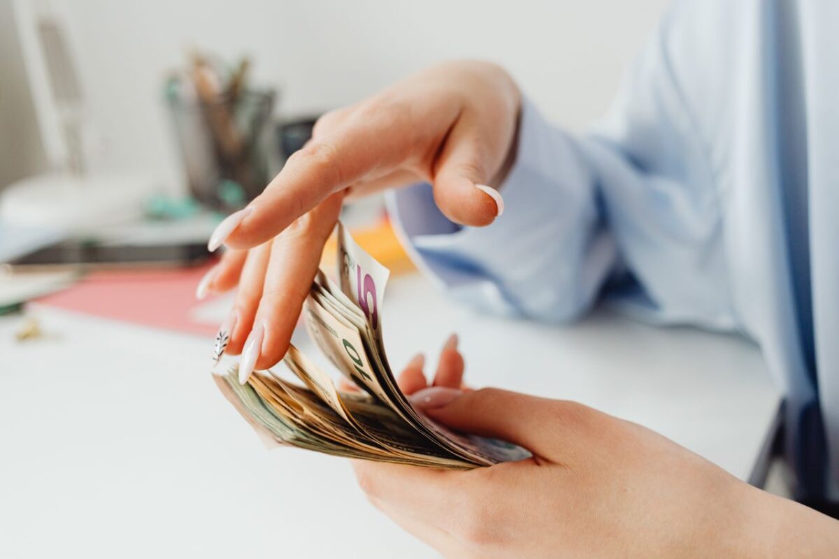 Persona tiene in mano delle banconote Persona tiene in mano delle banconote